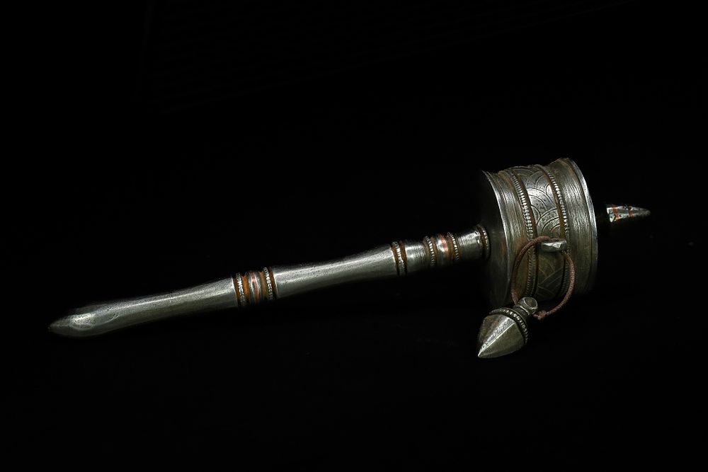 Lot 264: A Tibetan or Himalayan Iron Handheld Prayer Wheel....