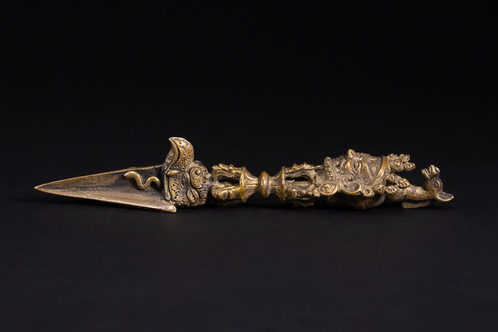 Lot 269: A Tibetan Brass Phurba (Ritual Dagger) with Wrathful...