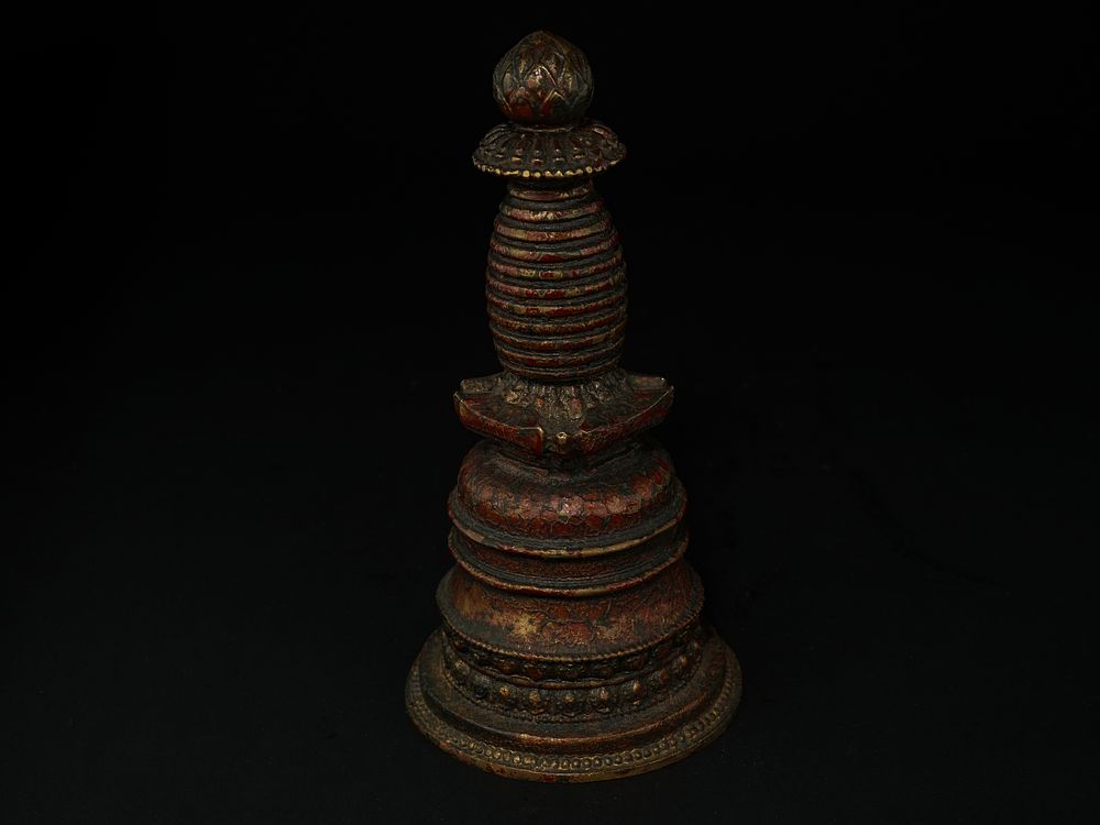 Lot 276: A Tibetan Gilt Bronze Stupa-Form Ritual Finial.