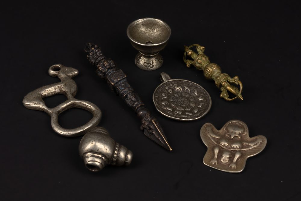 Lot 277: A Collection of Tibetan Mixed Metal Ritual Objects.
