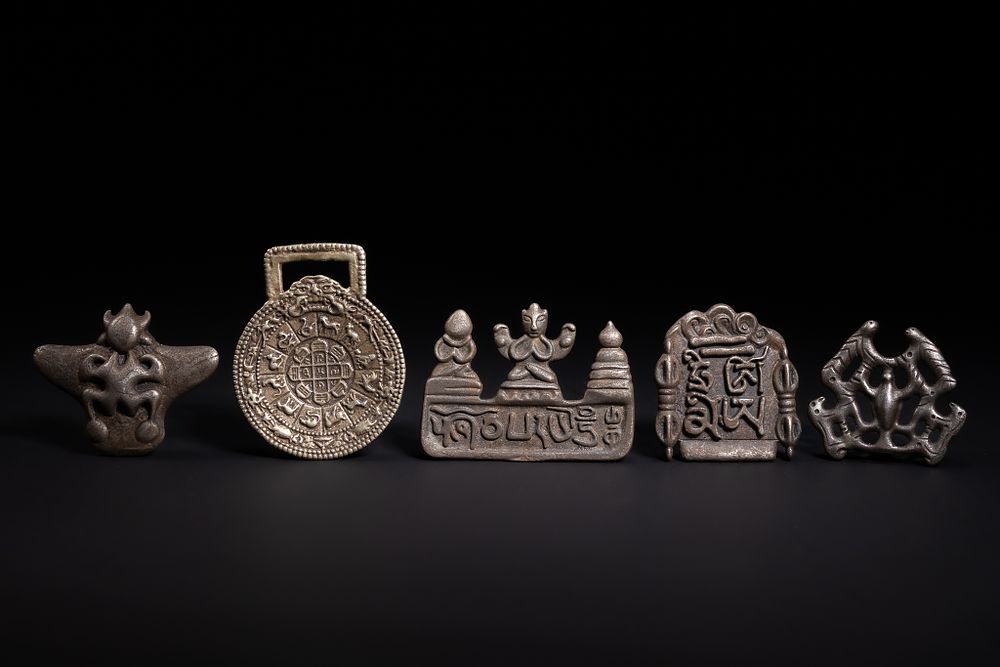 Lot 279: A Collection of Tibetan White Metal Amulets and...