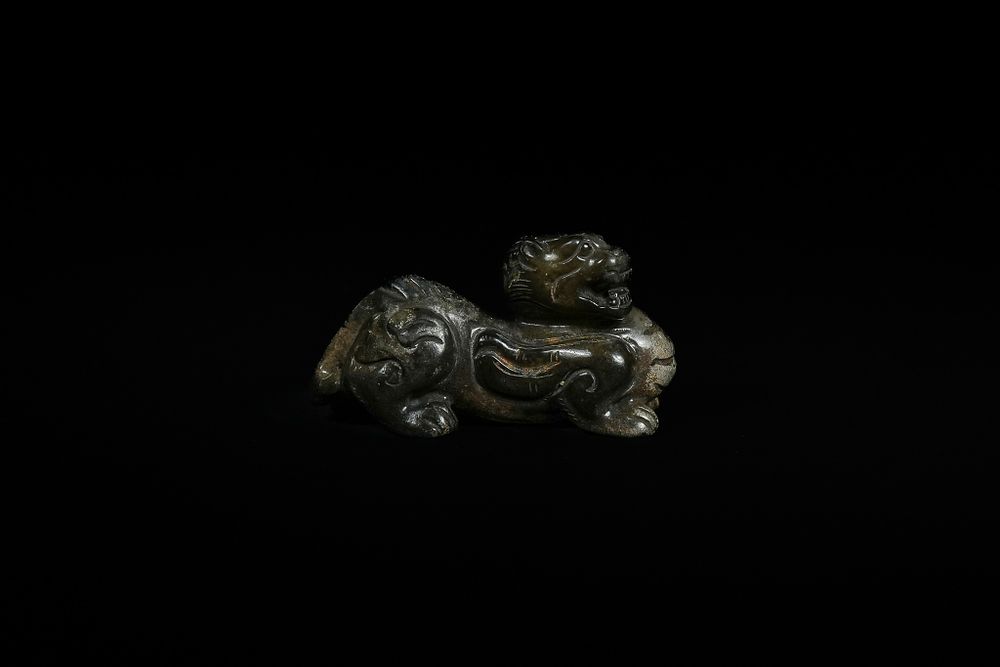 Lot 336: A Chinese Jade Carving of a Recumbent Mythical...