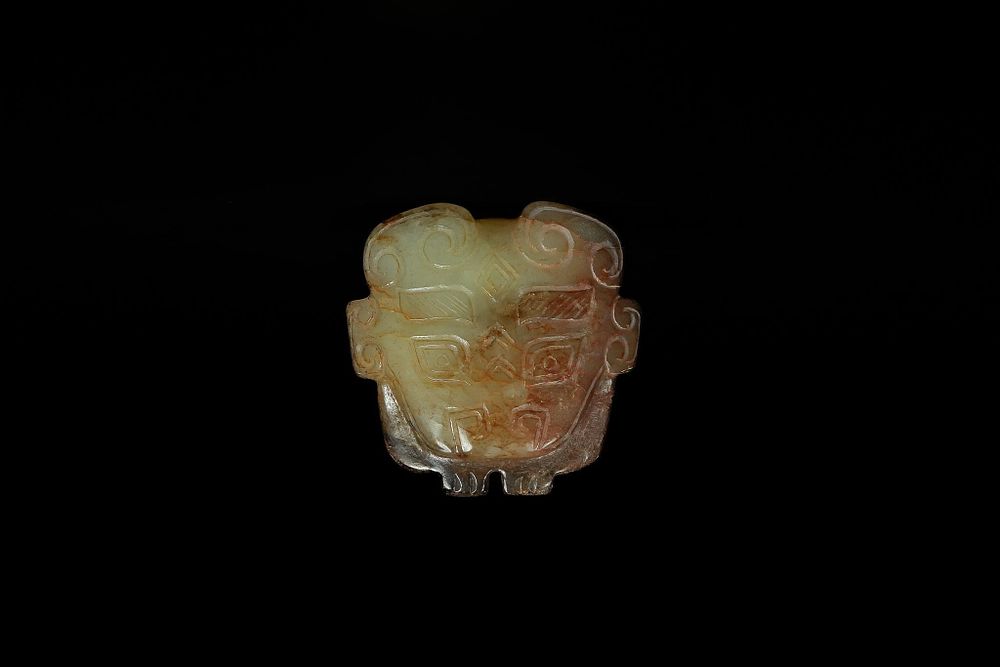 Lot 337: A Chinese Jade Pendant with Stylised Mask Motif,...