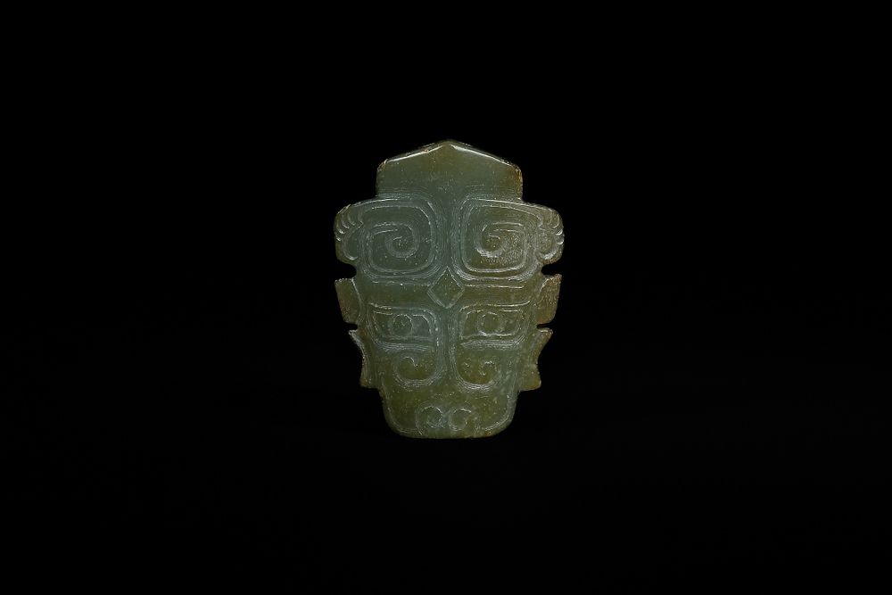 Lot 338: A Chinese Hetian Jade 'Taotie' Maskette, Late Qing...