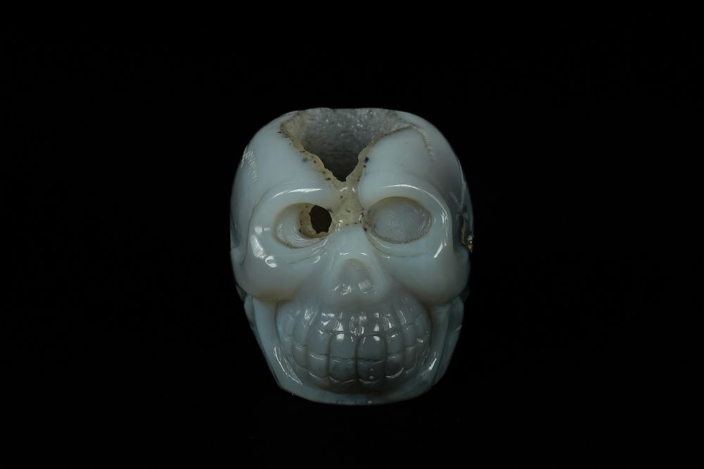 Lot 344: A Chinese Agate Geode Carved Agate Skull. -