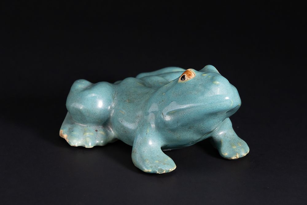 Lot 360: A Chinese Celadon-Glazed Model of a Recumbent Frog.