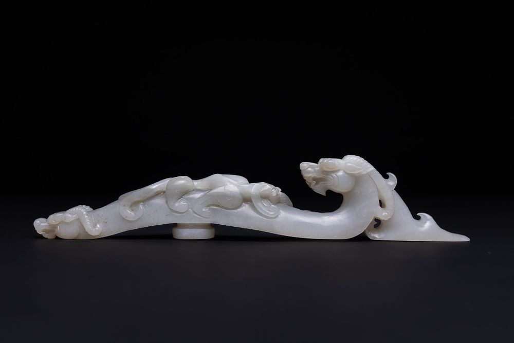 Lot 198: A Chinese Jade Carving of a Stylised Dragon...