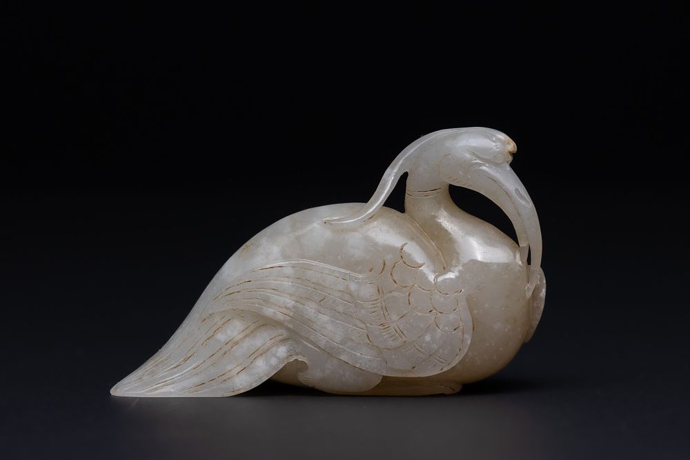Lot 199: A Chinese Jade Carving of a Stylised Bird...