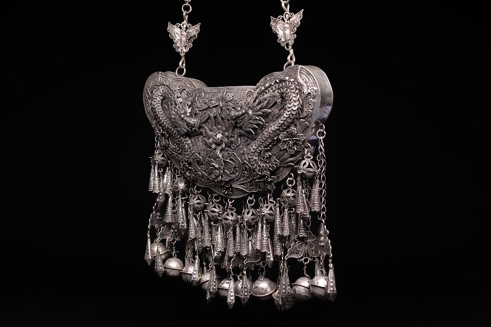 Lot 200: A Chinese White Metal Filigree Ornate Dragon-Decorated Pendant...