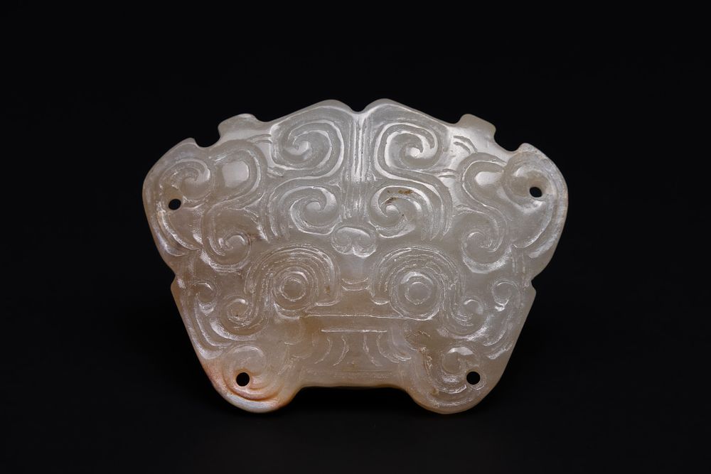 Lot 204: A Chinese Jade Carved Mask Plaque, 18th-19th Century.