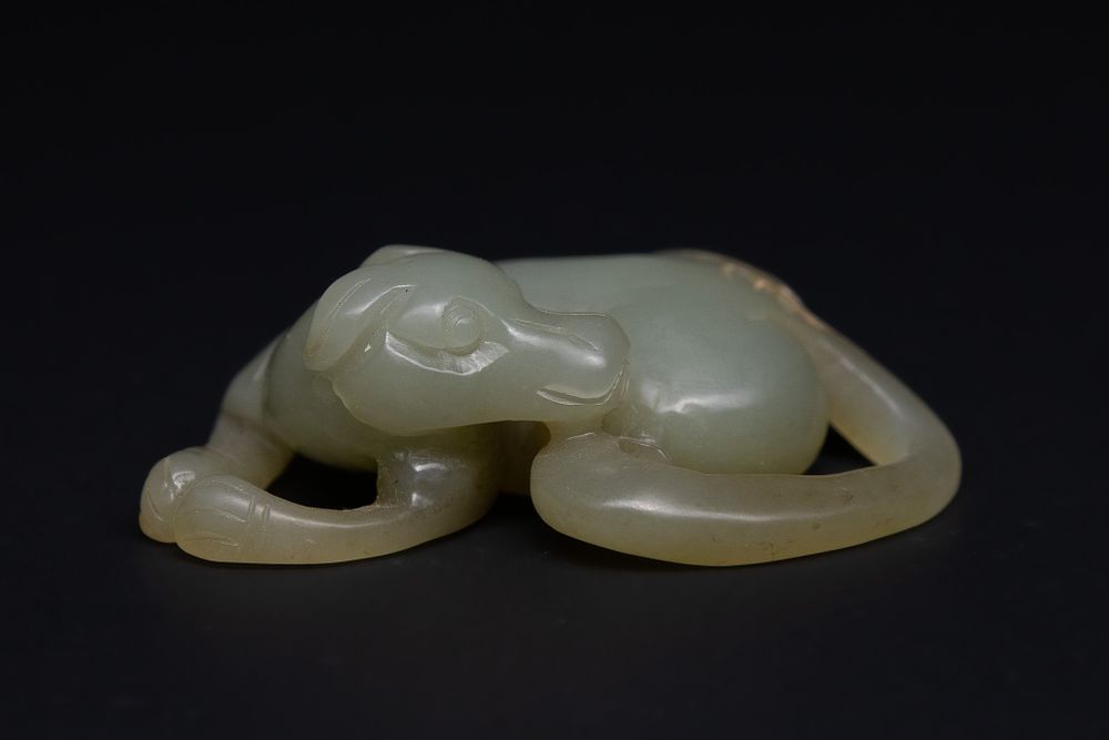 Lot 208: A Chinese Jade Carving of a Recumbent Hound.