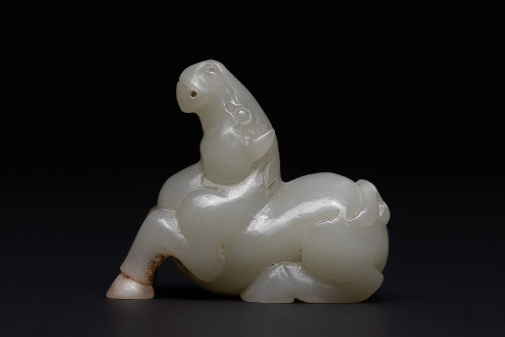 Lot 211: A Chinese Jade Carving of a Recumbent Horse.
