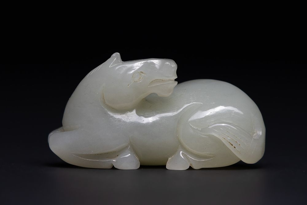 Lot 212: A Chinese Jade Carving of a Recumbent Mythical...