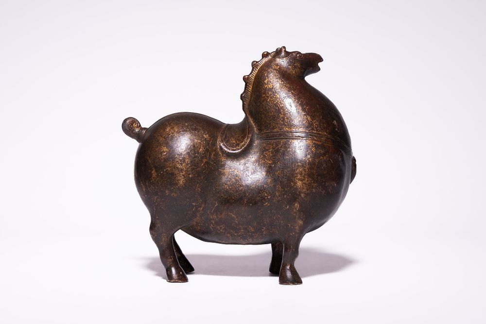 Lot 223: A Chinese Bronze Model of a Stylised Horse,...