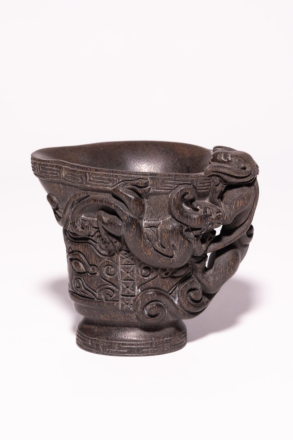 Lot 231: A Chinese Libation Cup with Mythical Beast Handles.