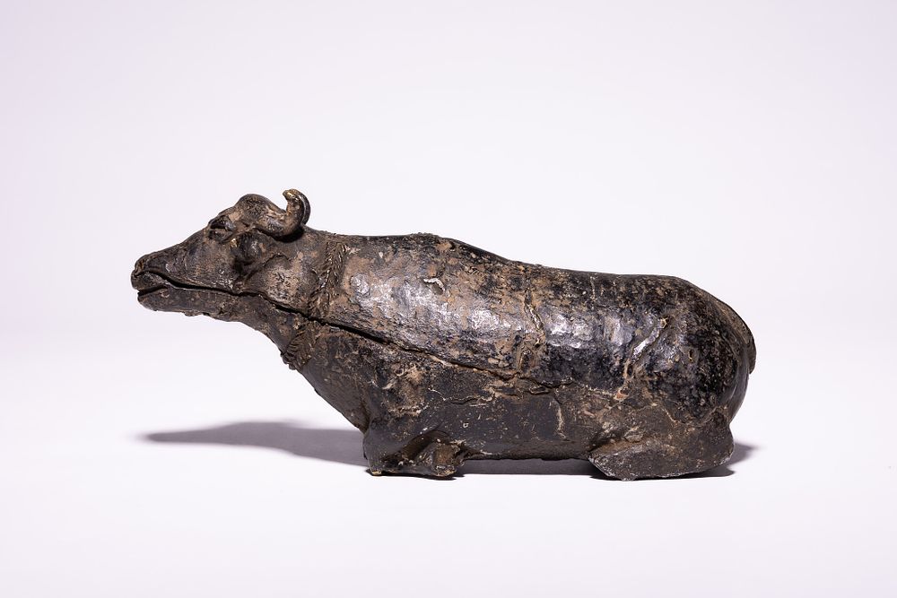 Lot 237: A Chinese Cast Bronze Figure of a Recumbent...