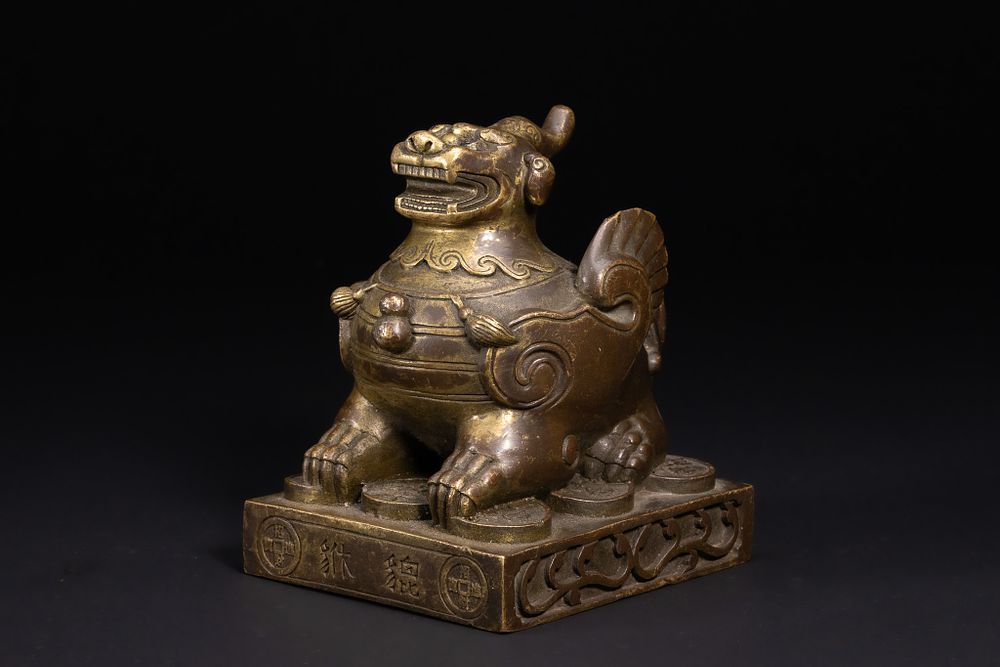 Lot 238: A Chinese Bronze Mythical Beast-Form Weight or Architectural...