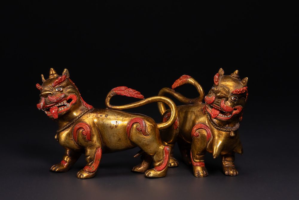 Lot 239: A Pair of Chinese Gilt-Decorated Foo Lions (Guardian...