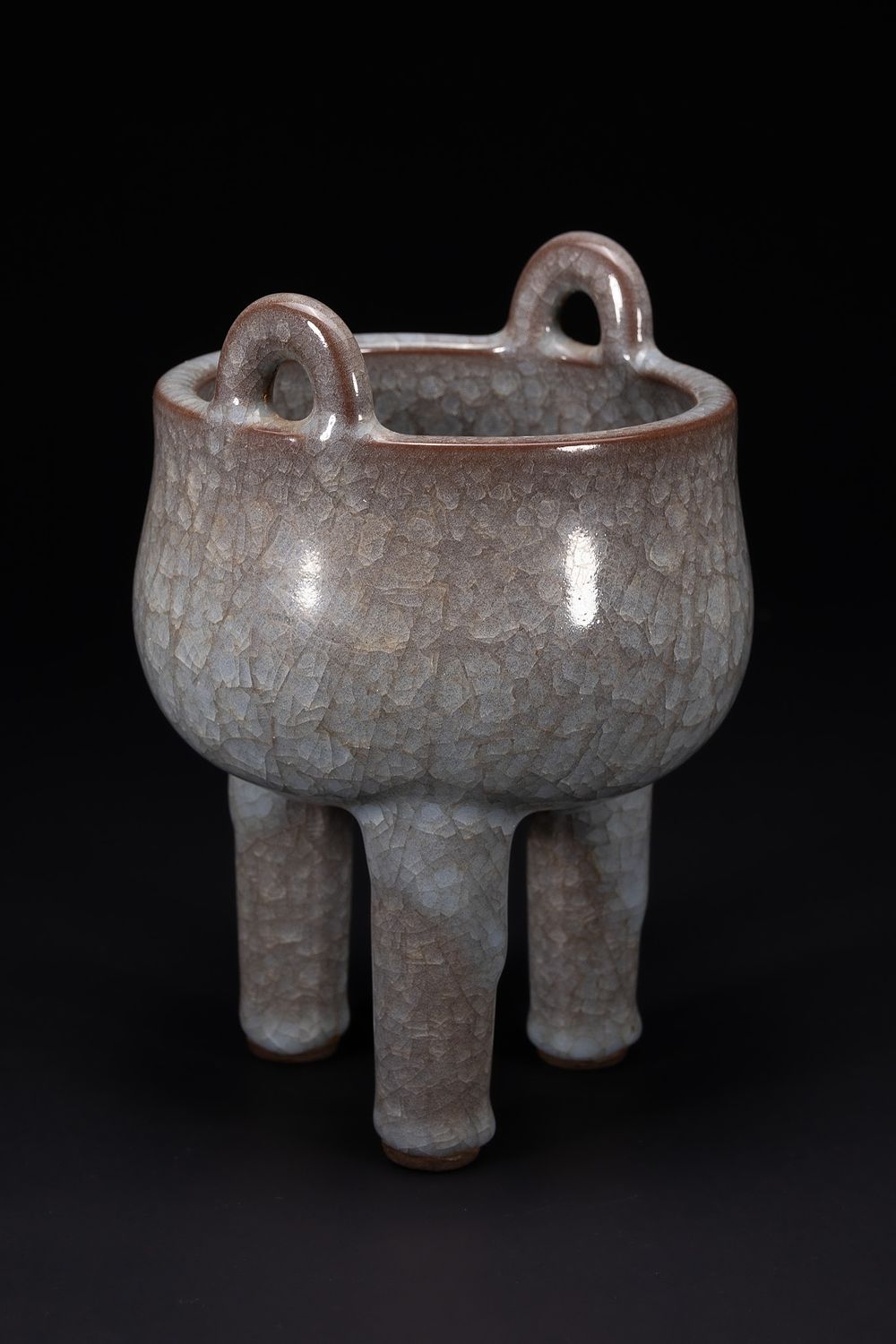 Lot 278: A Chinese Crackle-Glazed Tripod Censer with Loop Handles.