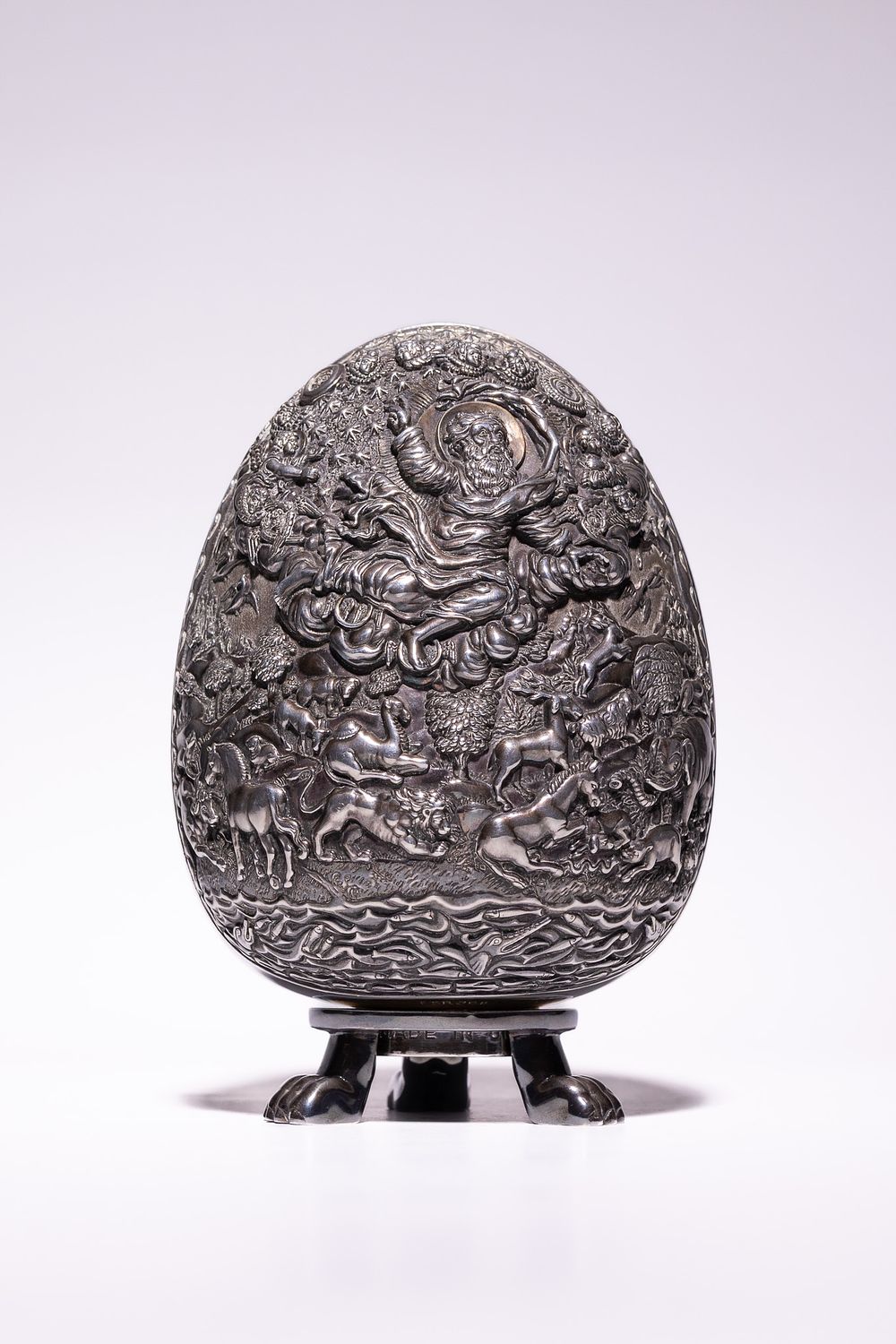 Lot 336: A Continental Silver Egg-Form Religious Relief Sculpture, Marked...