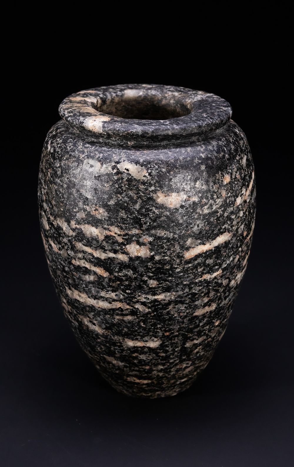 Lot 3: AN ANCIENT EGYPTIAN GRANITE OVOID JAR, CIRCA 4TH-3RD MILLENNIUM BC.