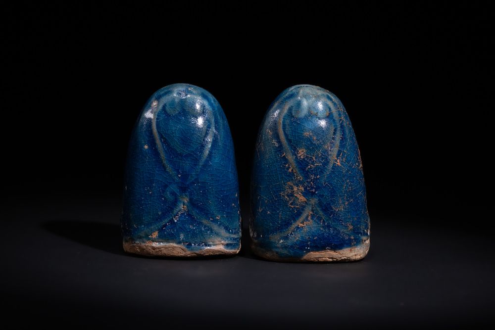 Lot 10: A PAIR OF GLAZED CERAMIC GAMING PIECES, POSSIBLY FATIMID 12TH CENTURY.