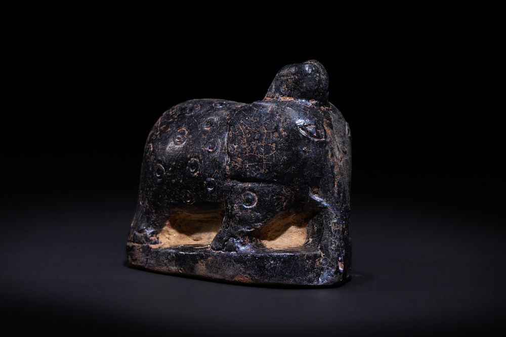Lot 14: AN ISLAMIC GLAZED CERAMIC ELEPHANT-FORM CHESS PIECE, POSSIBLY 10TH–12TH CENTURY.