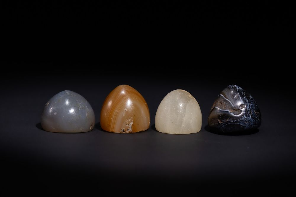 Lot 18: A LOT OF FOUR ISLAMIC AGATE GAMING PIECES, POSSIBLY ANCIENT.