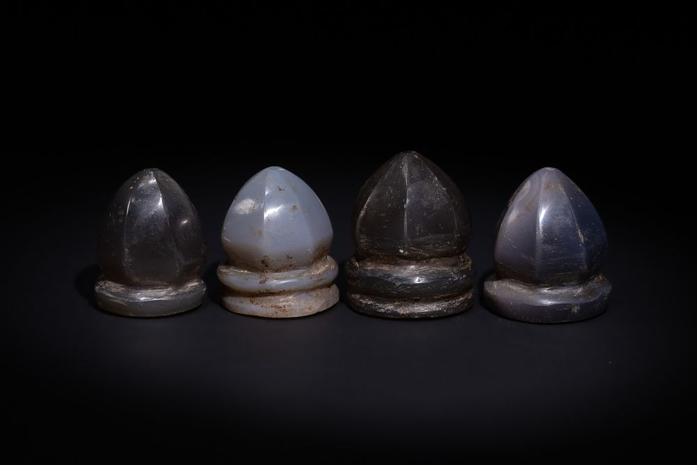 Lot 19: A LOT OF FOUR ISLAMIC AGATE GAMING PIECES, POSSIBLY ANCIENT.