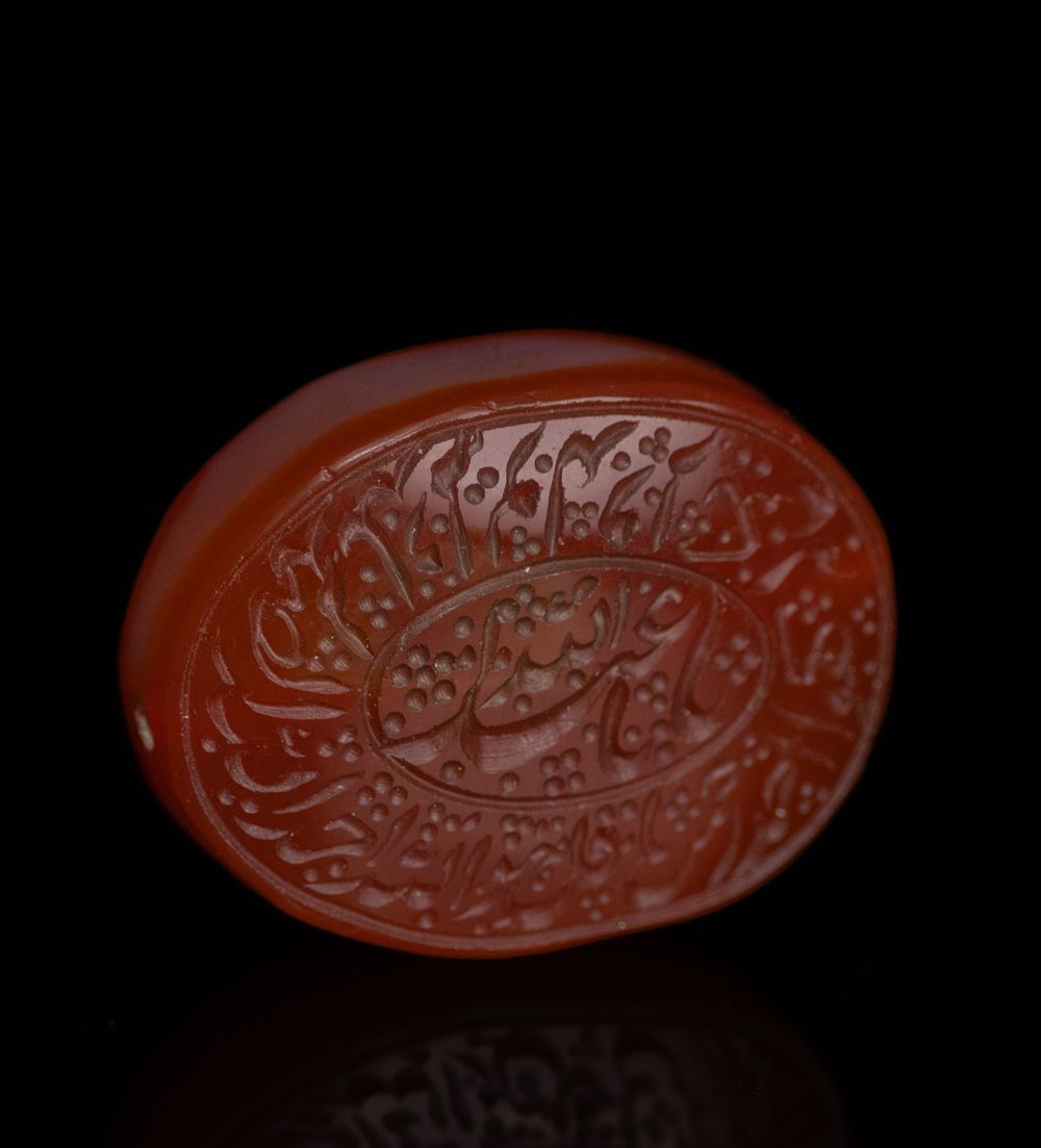 Lot 24: AN ISLAMIC CALLIGRAPHIC CARNELIAN INTAGLIO SEAL STONE.