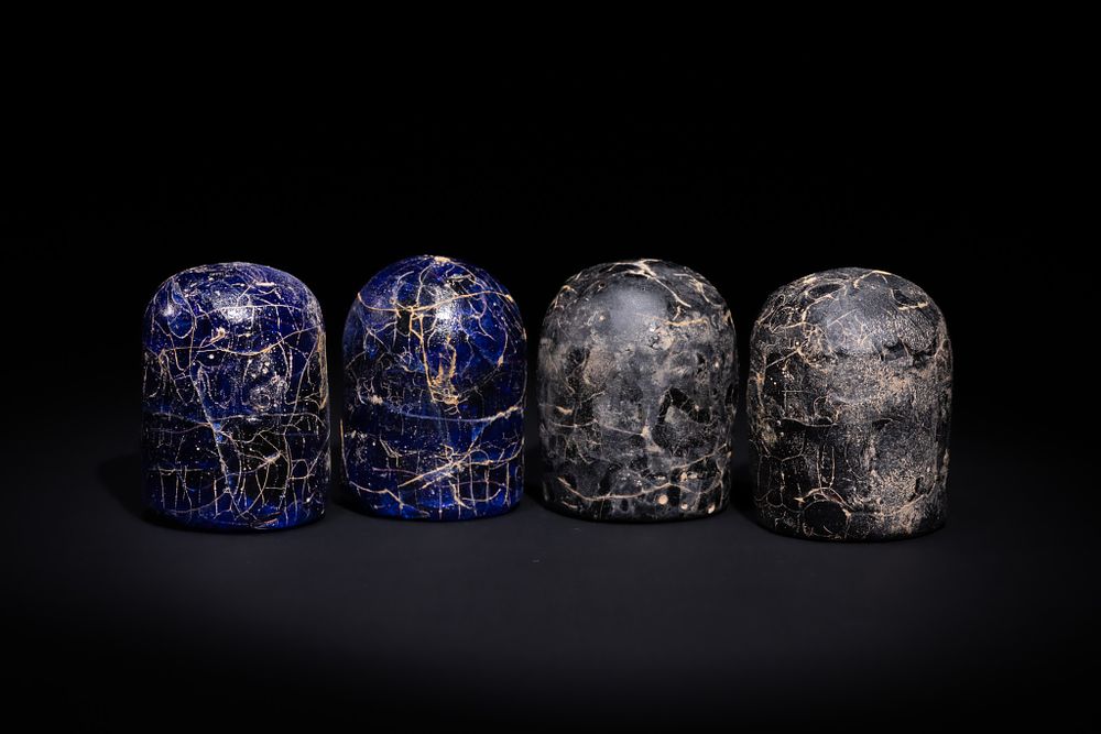 Lot 25: A GROUP OF FOUR ISLAMIC BLUE AND BLACK GLASS GAMING PIECES, PROBABLY SYRIA, 13TH CENTURY OR LATER.