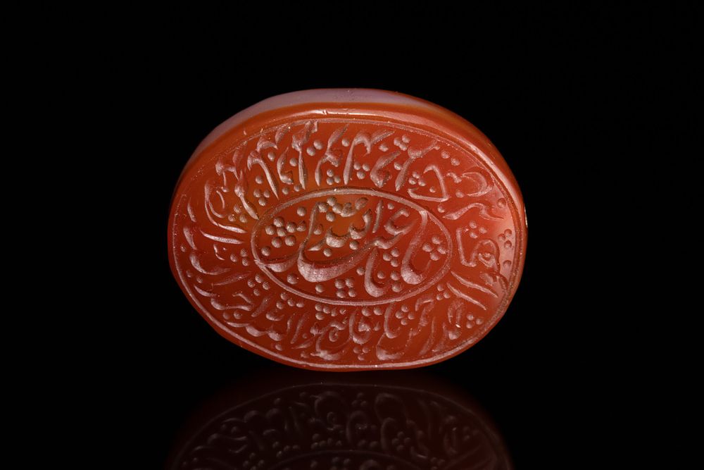 Lot 26: AN ISLAMIC CARVED CARNELIAN AGATE INTAGLIO SEAL.