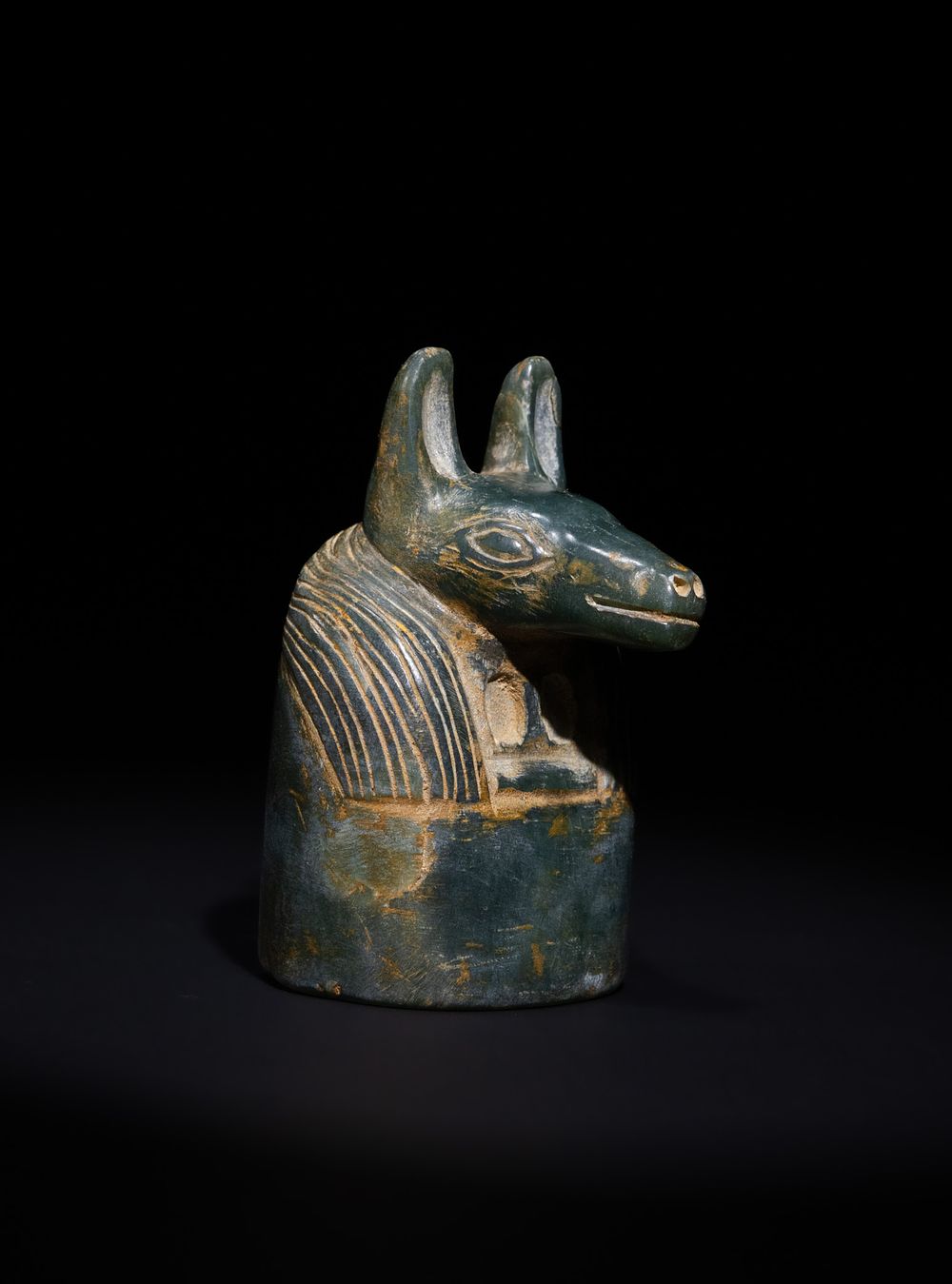 Lot 32: AN EGYPTIAN REVIVAL CARVED STONE ANUBIS GAMING PIECE, 19TH CENTURY.