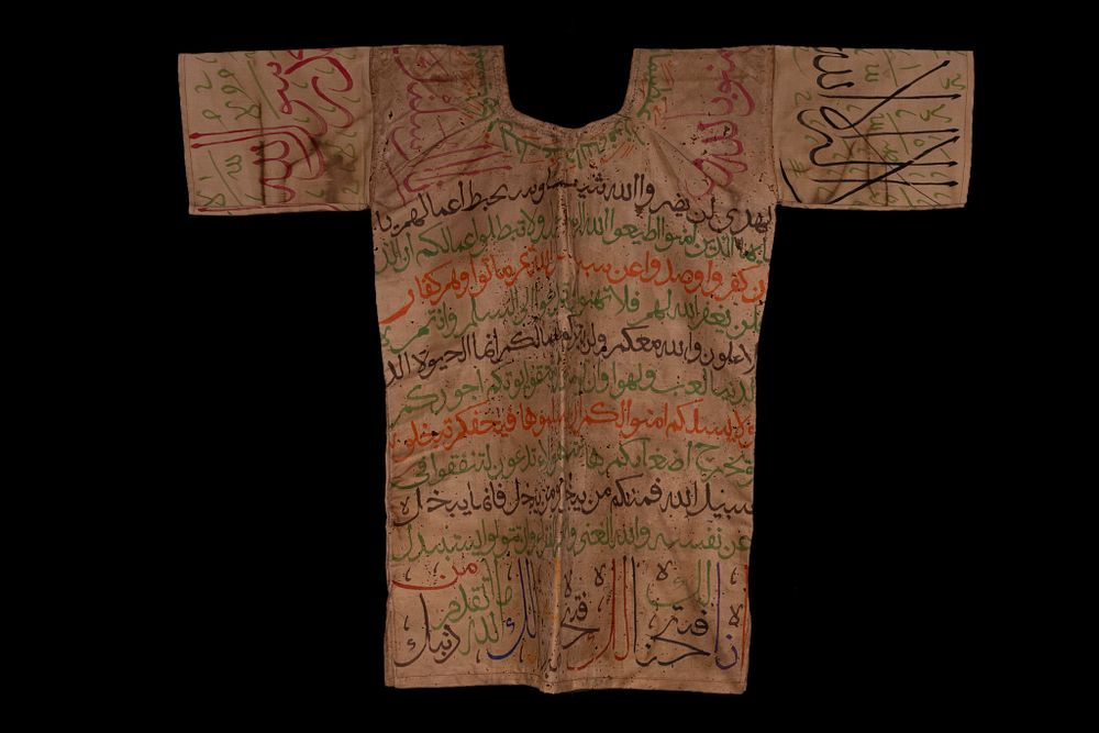 Lot 45: AN OTTOMAN TALISMANIC SHIRT WITH QURANIC CALLIGRAPHY AND MAGIC SQUARES.