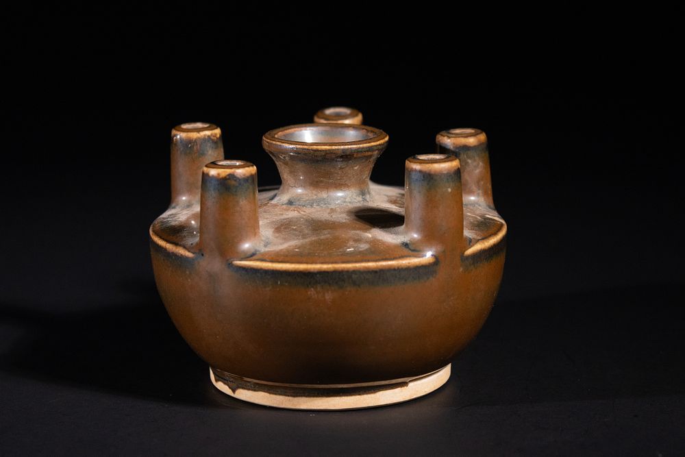 Lot 55: A CHINESE BROWN-GLAZED FIVE-SPOUT STONEWARE VESSEL.