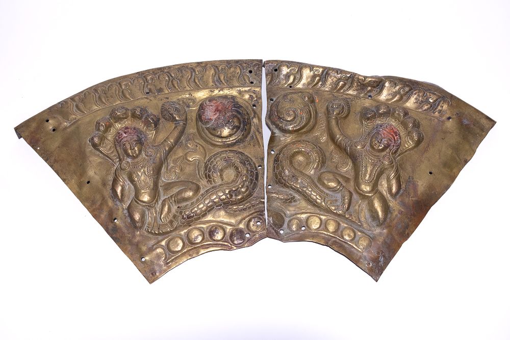 Lot 56: A PAIR OF NEPALESE RITUAL REPOUSSÉ COPPER ALLOY NAGA PLAQUES, 18TH-19TH CENTURY.