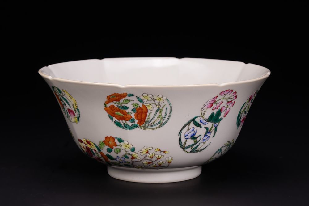 Lot 89: A CHINESE FAMILLE ROSE FLORAL MEDALLION LOBED PORCELAIN BOWL.