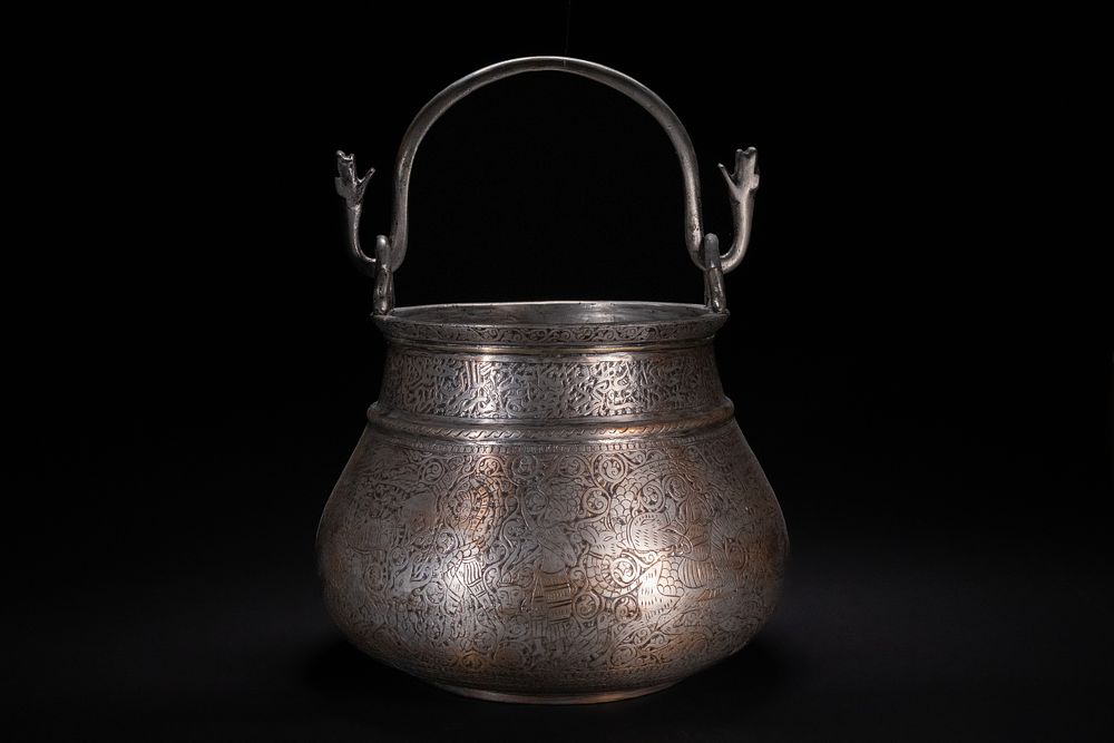 Lot 97: A QAJAR TINNED COPPER VESSEL WITH ARABIC CALLIGRAPHY AND FIGURAL SCENES, 19TH CENTURY..