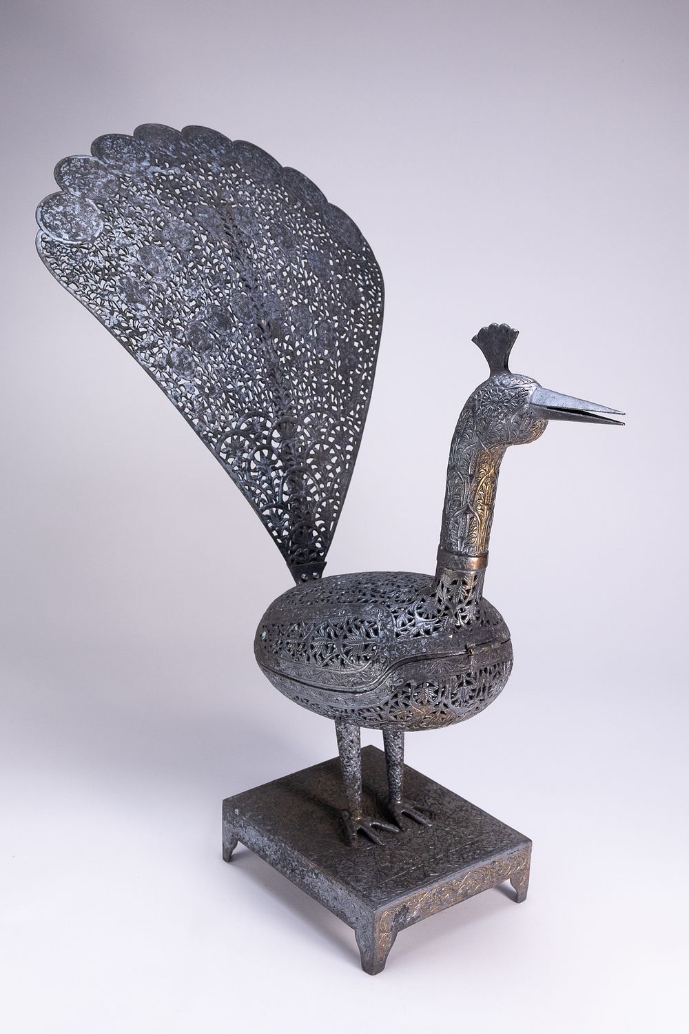 Lot 105: A QAJAR STYLE OPENWORK STEEL PEACOCK INCENSE BURNER.