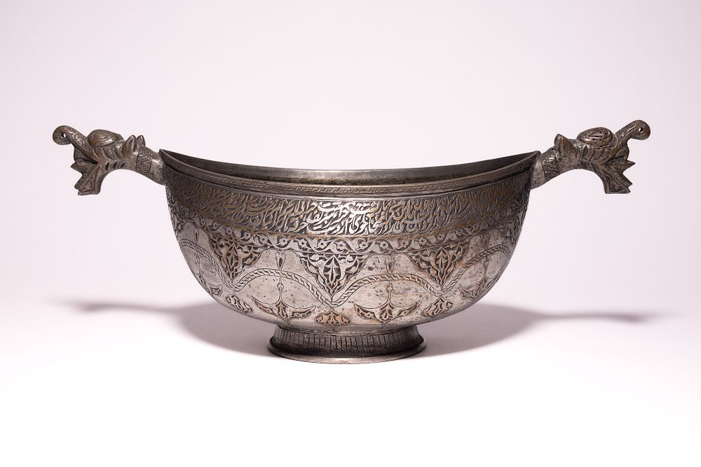 Lot 106: A LARGE PERSIAN QAJAR TINNED COPPER KASHKUL, 19TH CENTURY.