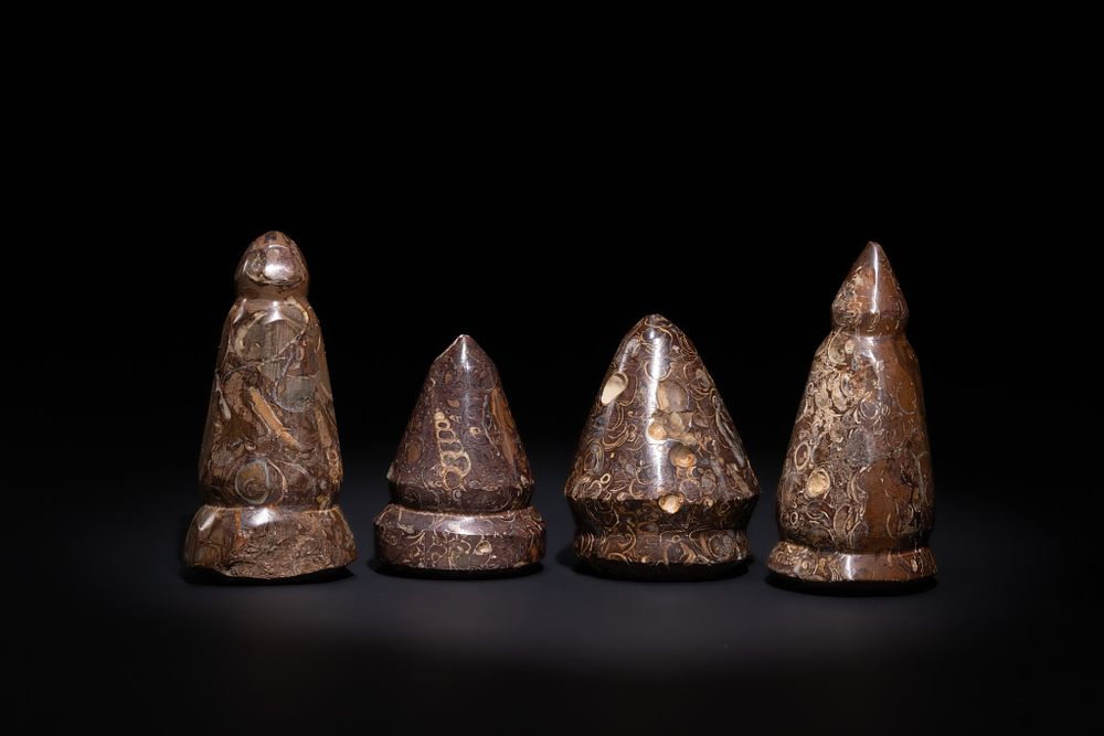 Lot 115: A LOT OF FOUR ISLAMIC STONE GAMING PIECES, 19TH CENTURY.