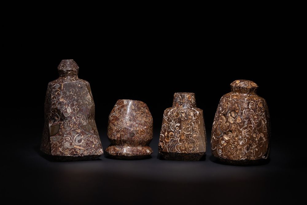 Lot 117: A LOT OF FOUR ISLAMIC FOSSILIFEROUS MARBLE GAMING PIECES, 19TH CENTURY.