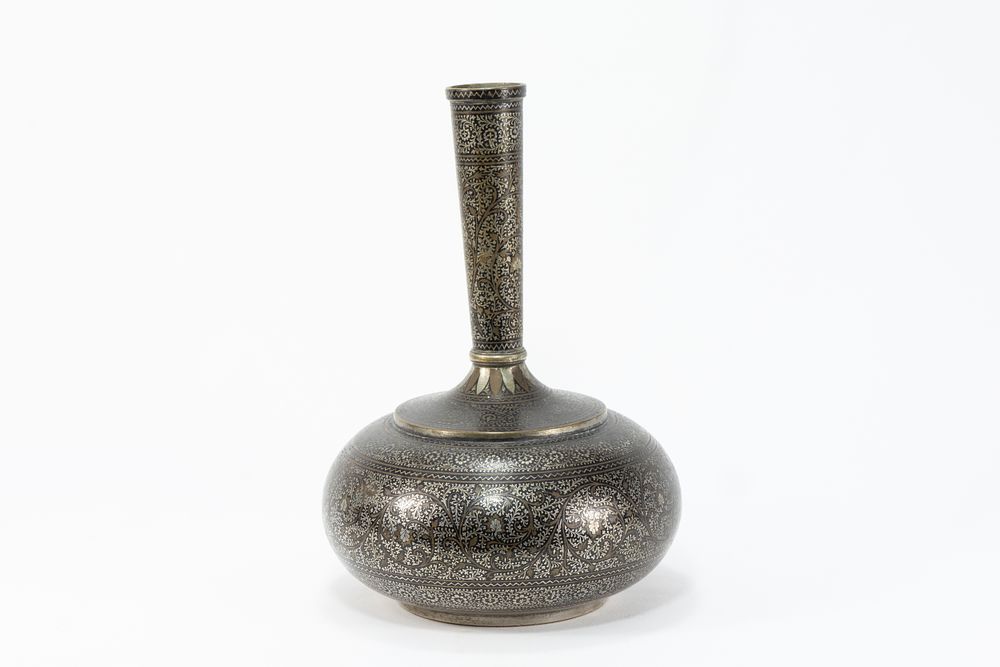 Lot 119: AN INDO-PERSIAN NIELLO BRASS VASE WITH SILVER AND COPPER INLAY, 19TH CENTURY.