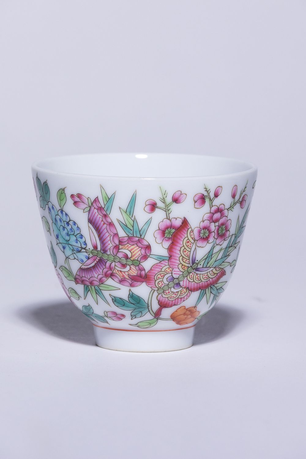 Lot 186: A CHINESE FAMILLE ROSE HUNDRED BUTTERFLIES PORCELAIN CUP, GUANGXU MARK .