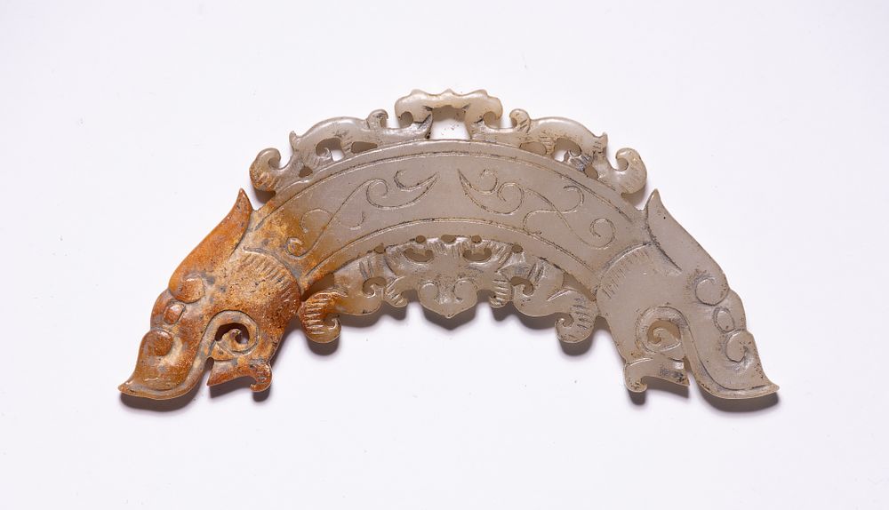 Lot 187: A CHINESE CARVED JADE DOUBLE-DRAGON RITUAL HUANG PENDANT.