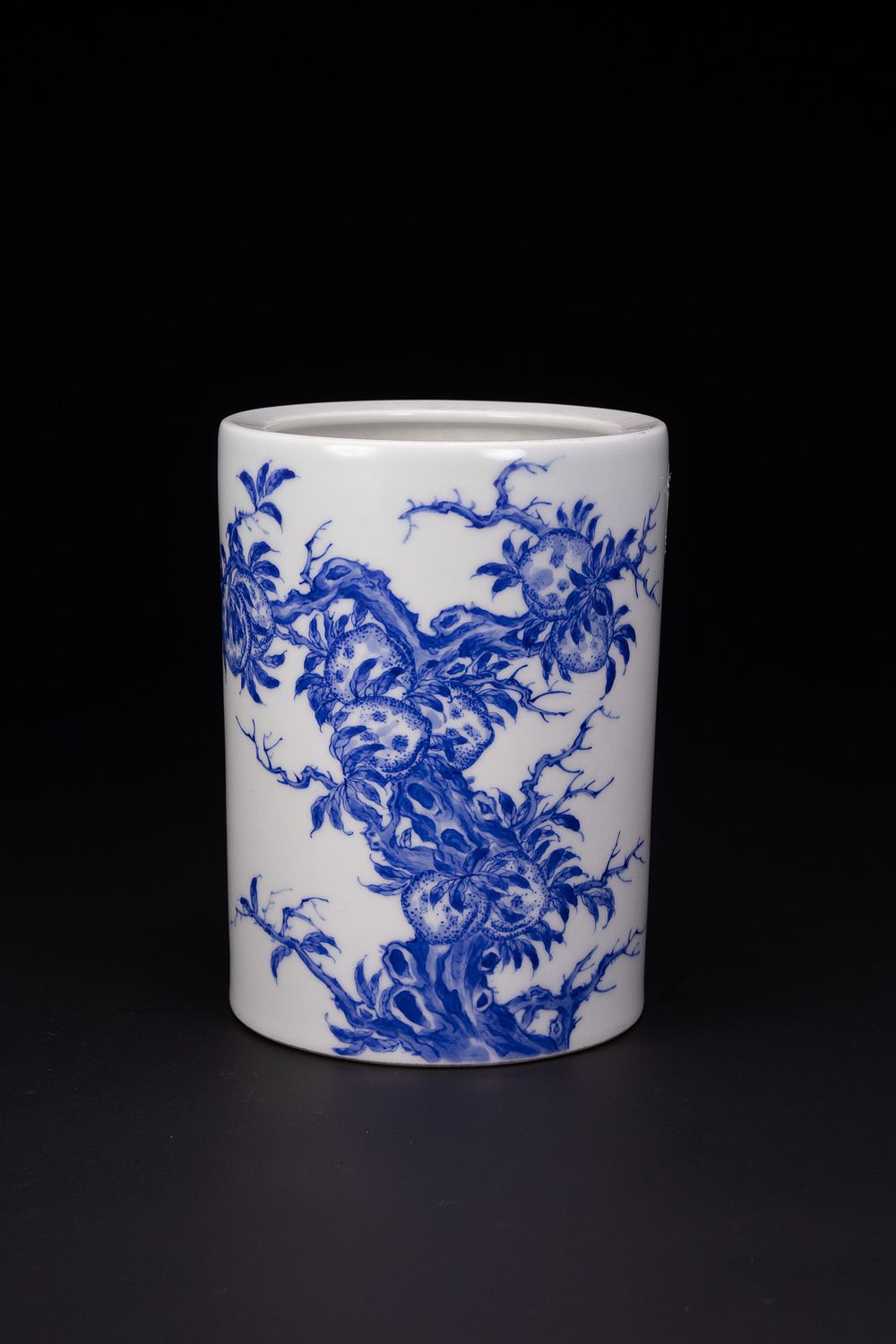 Lot 196: A CHINESE BLUE AND WHITE PORCELAIN PEACH TREE BRUSH POT BITONG, WANG BU MARK.