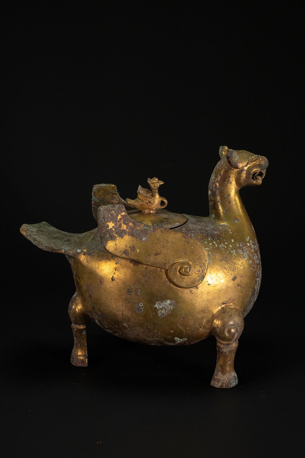 Lot 199: A CHINESE GOLD GILT-BRONZE ZOOMORPHIC DRINKING VESSEL WITH PHOENIX FINIAL, 19TH CENTURY.