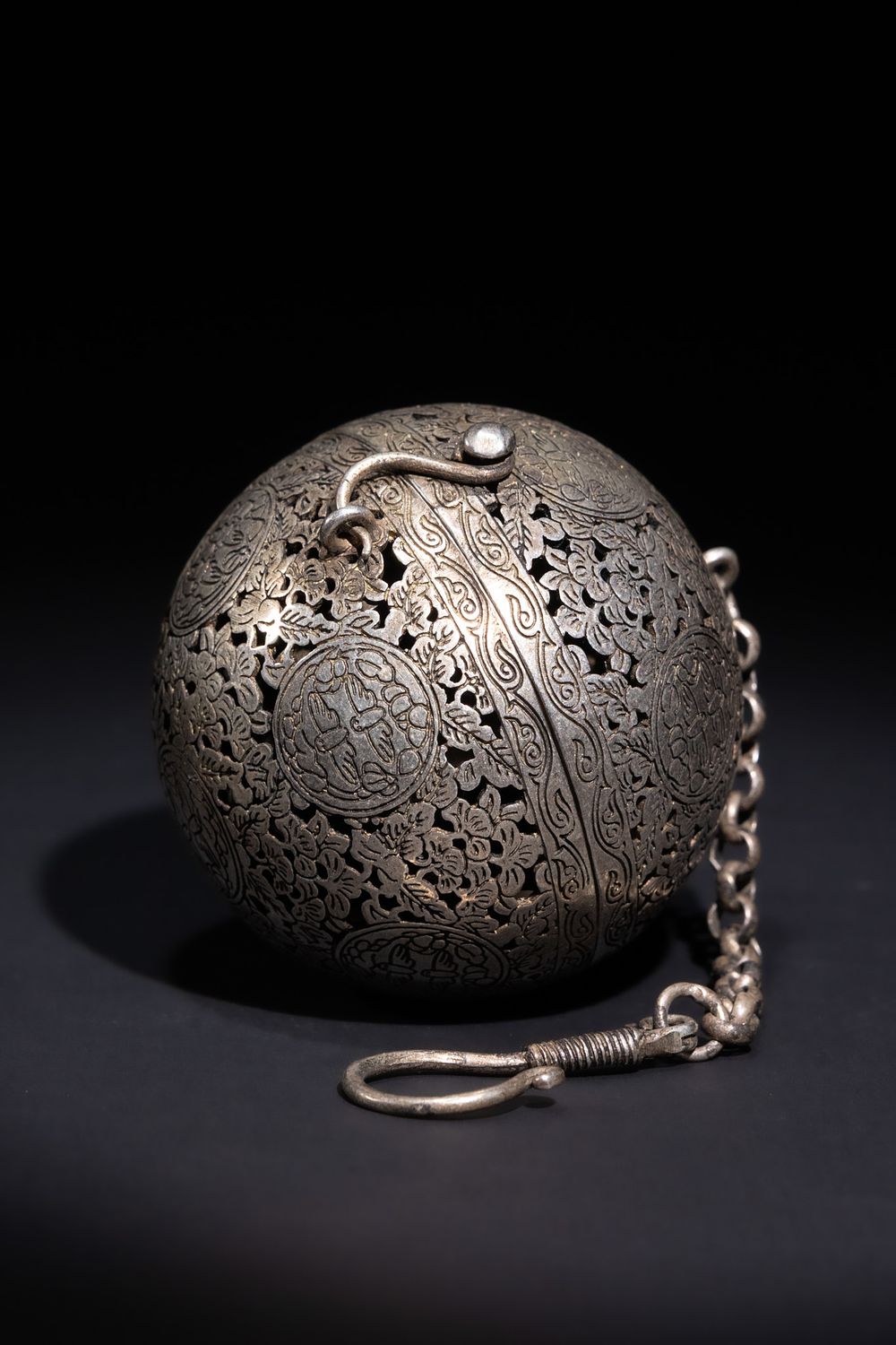 Lot 222: A CHINESE PIERCED WHITE-METAL SPHERICAL INCENSE BURNER.