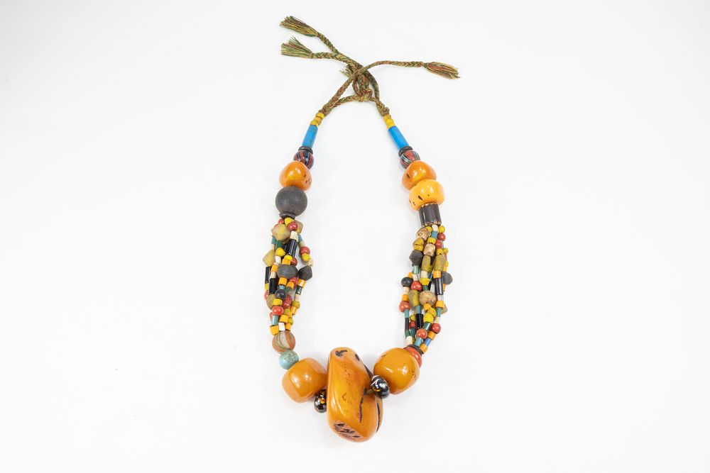 Lot 234: A LARGE TRIBAL MOROCCAN AMBER-COLOURED BEADED NECKLACE.