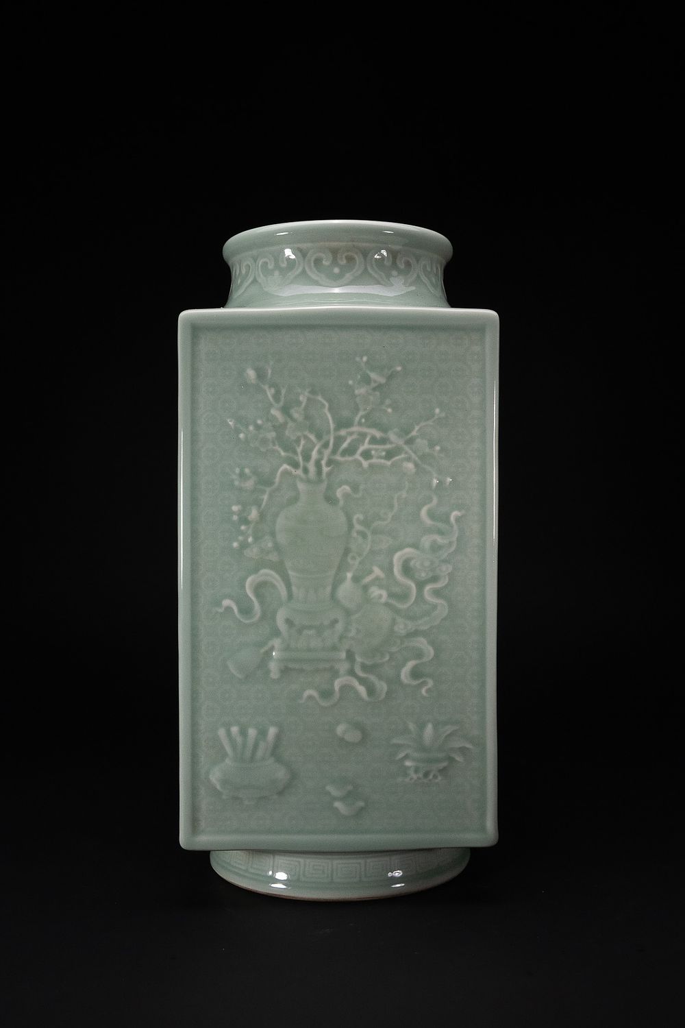 Lot 246: A CHINESE CELADON-GLAZED RELIEF-MOULDED RECTANGULAR CONG-FORM VASE, QIANLONG MARK.